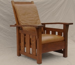 Stickley Era Quaint Art Slant Arm Morris Chair with leather cushions.